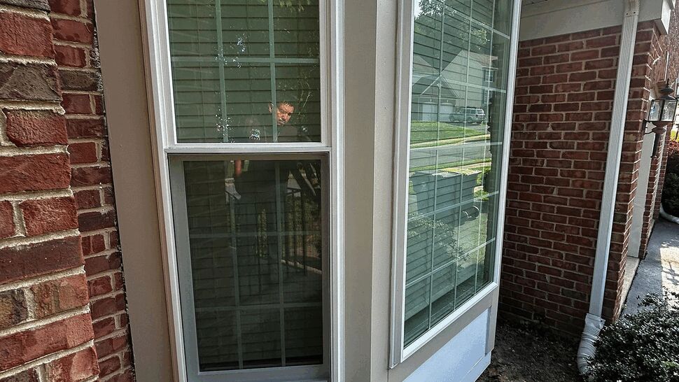 Side angle of bay window showing window sash, trim and base panels.