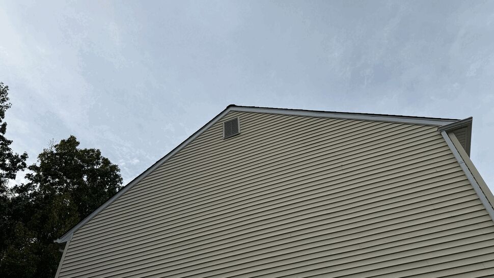 Sidewall Siding and Downspout | Tycos Roofing And Siding Inc Side wall of a home covered in cream horizontal siding with a white downspout