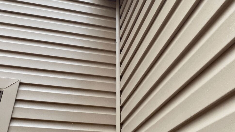 Close-up of vinyl siding corner and trim junction