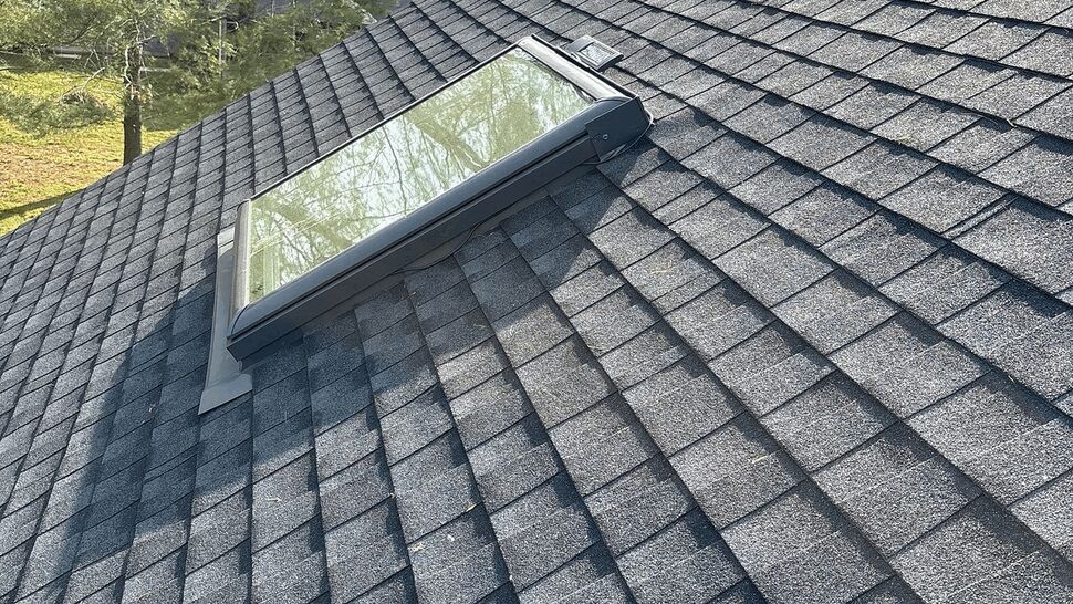 Asphalt shingle roof with a rectangular skylight installed