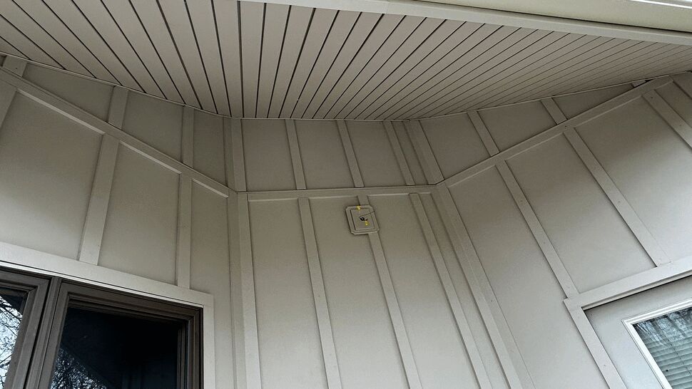 Close-up of soffit and porch ceiling panels above doorway