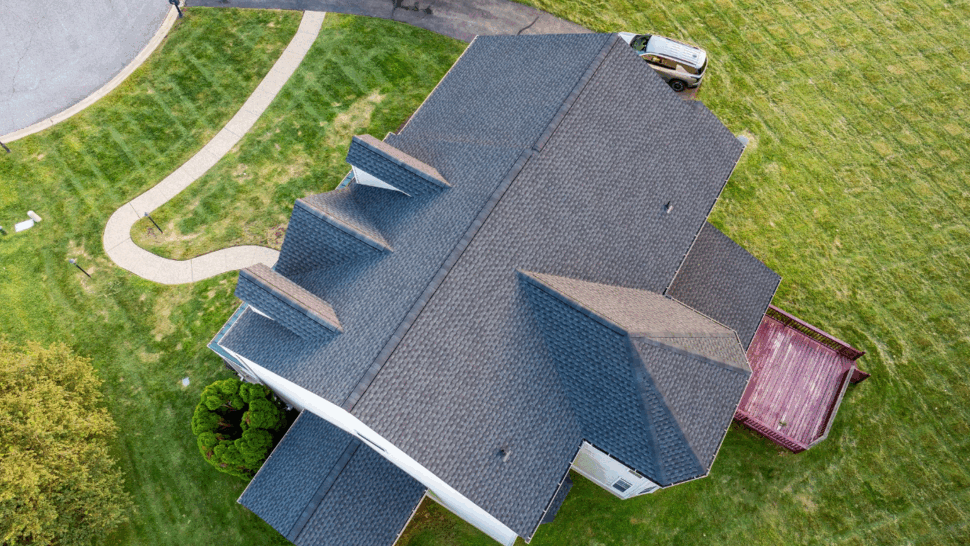 Top-down view of roof with three dormers and shingle pattern