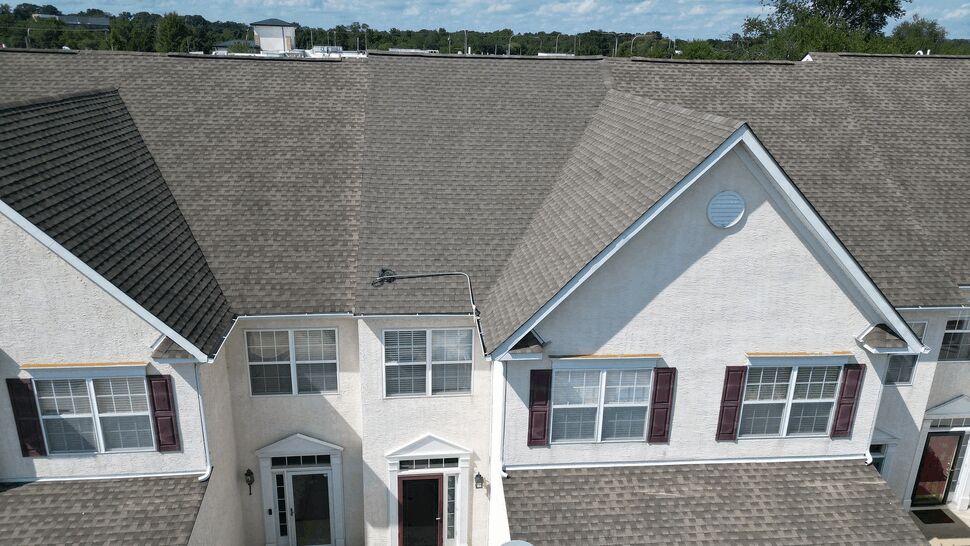 Aerial view of townhouse front roof with entry doors and gutters