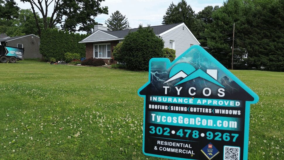 Lawn sign for Tycos Roofing And Siding Inc advertising roofing, siding, gutters and windows on a front yard