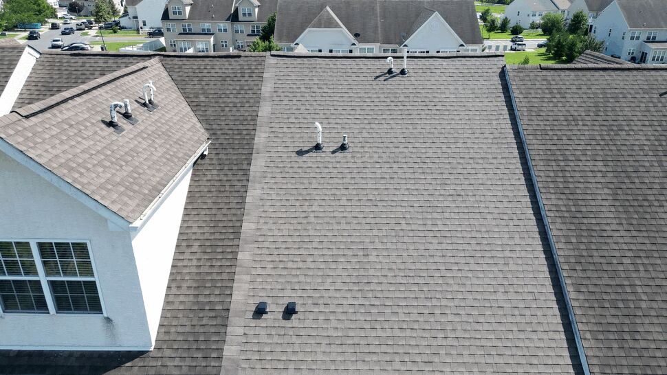 Wide rooftop view with plumbing vents across the shingled surface