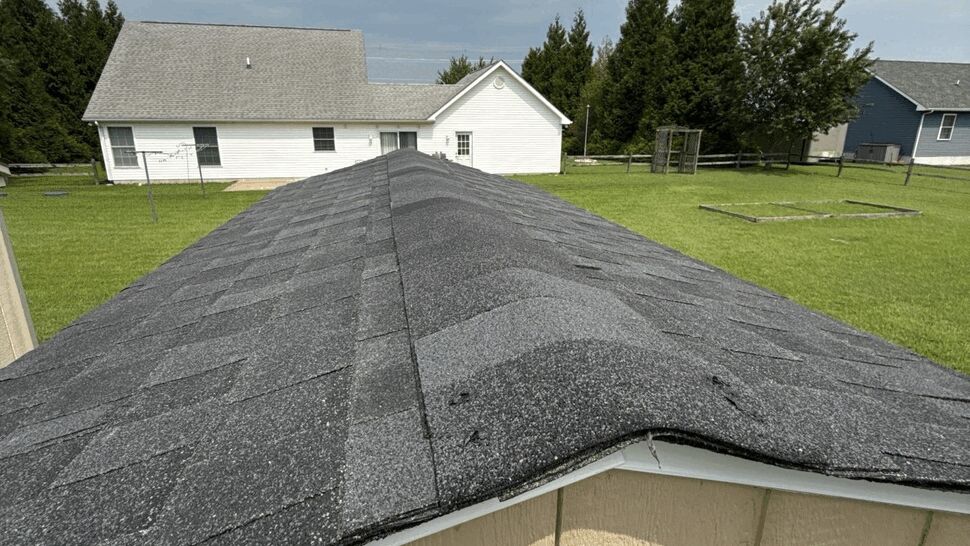 Dark Asphalt Shingle Roof | Top Roofing & Siding Close-up view of dark asphalt shingles on a residential roof.