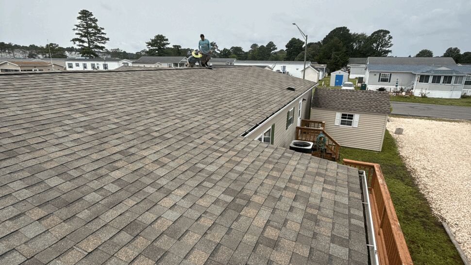 Gray Shingle Roof Overview | Top Roofing & Siding Wide view of gray asphalt shingle roofing in a residential community