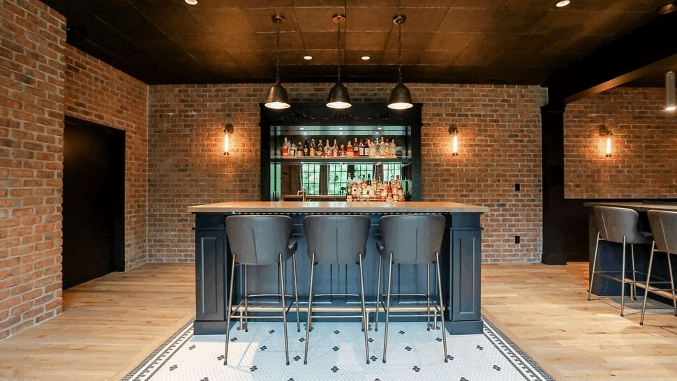 Bar island with four stools and decorative mosaic tile inset.