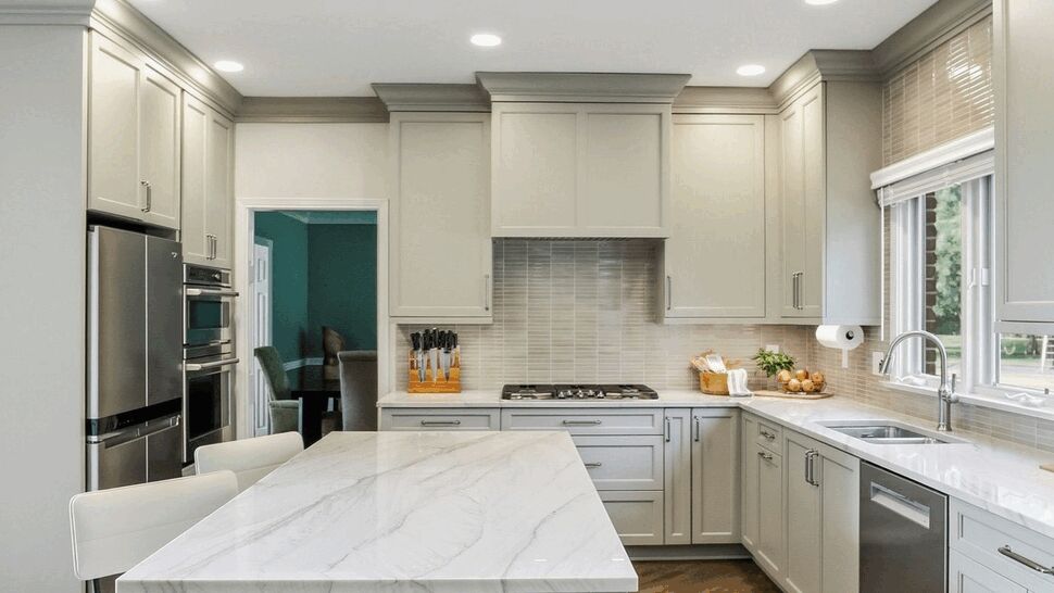 Full view of modern kitchen with gray cabinets and stainless appliances