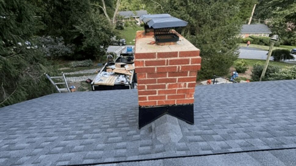 Close-up chimney flashing on new shingle roof
