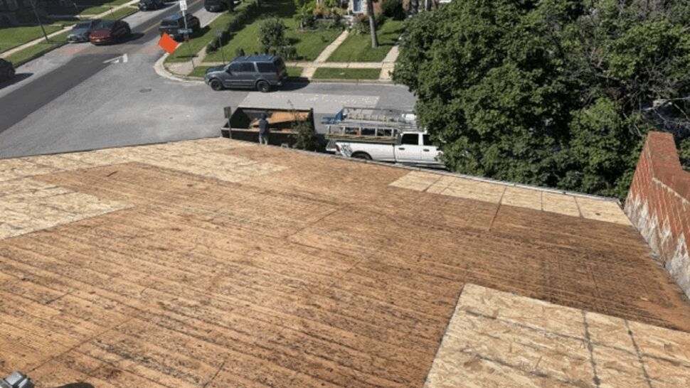 Exposed plywood roof deck ready for new shingles | Atlas Exteriors Wide shot of exposed plywood roof deck after old materials were removed.