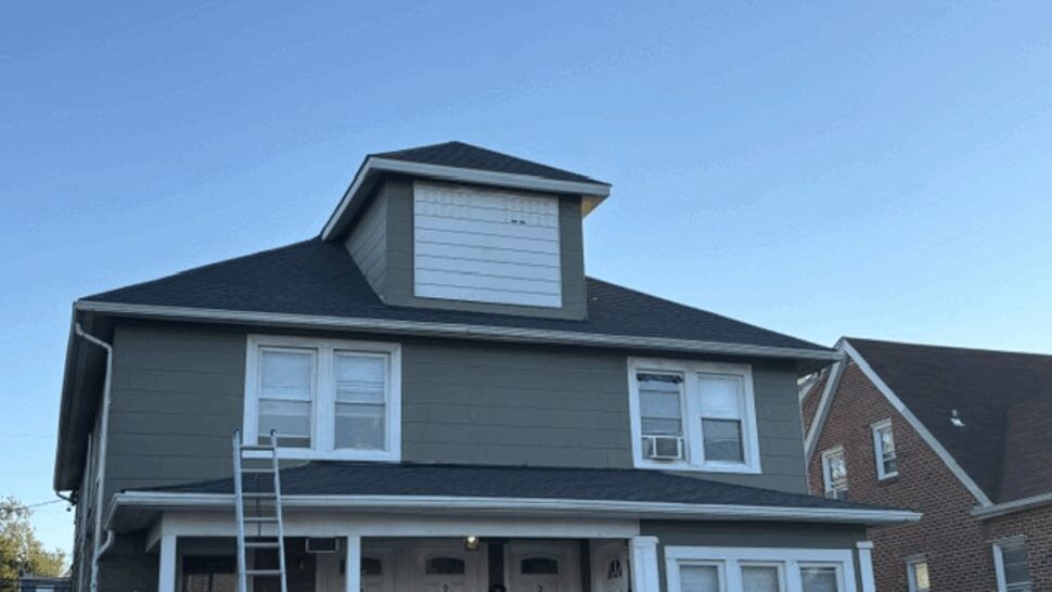Gray Home Roofing and Siding | Atlas Exteriors Gray-sided home with dark shingle roof and front porch