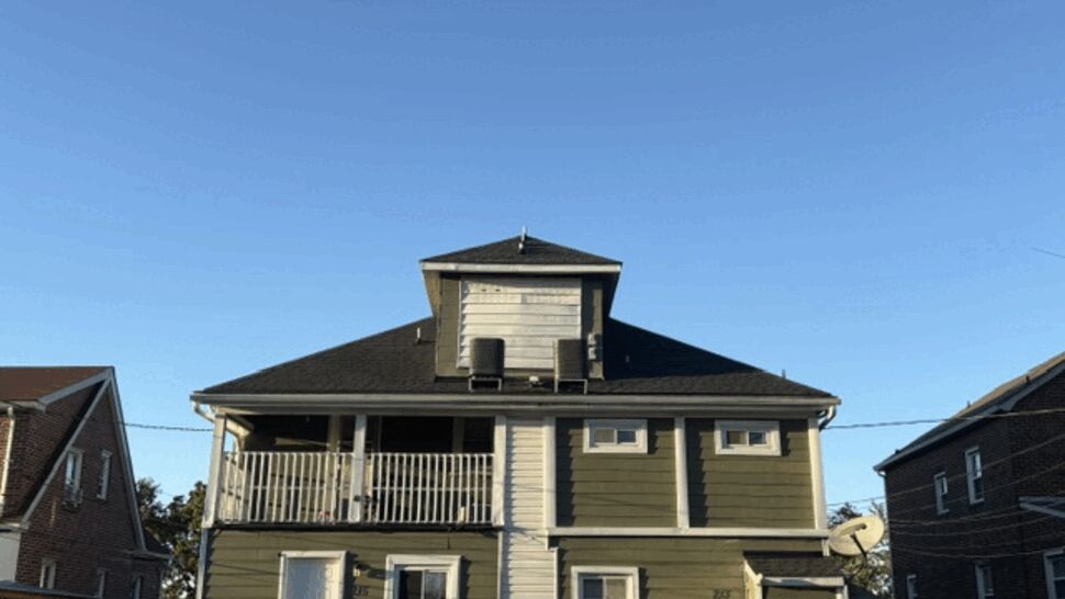 Green Siding and Dark Roof | Atlas Exteriors Green-sided house with dark roof and white trim