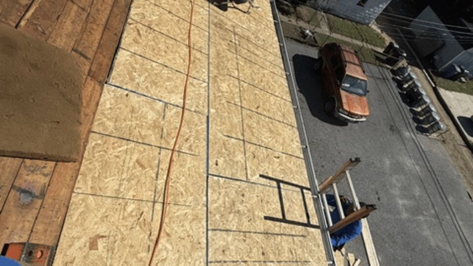 New Roof Decking Installation | Atlas Exteriors Fresh plywood roof decking installed around an air conditioner