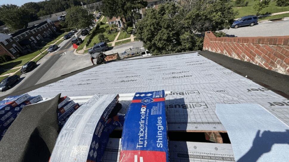 Shingle bundles and underlayment staging | Atlas Exteriors GAF shingle bundles staged on roof underlayment in preparation for shingle installation.