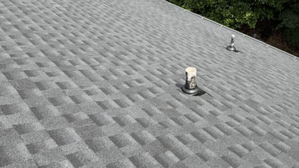 Shingle pattern close-up with plumbing vent boot and roof vent