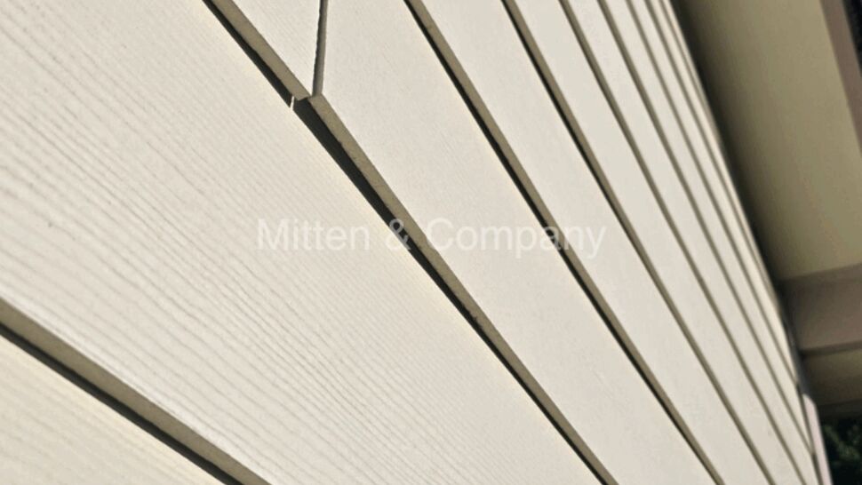 Close-up of beige horizontal lap siding with a small gap