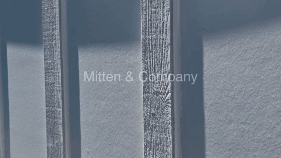 Close-up of vertical battens on painted white siding