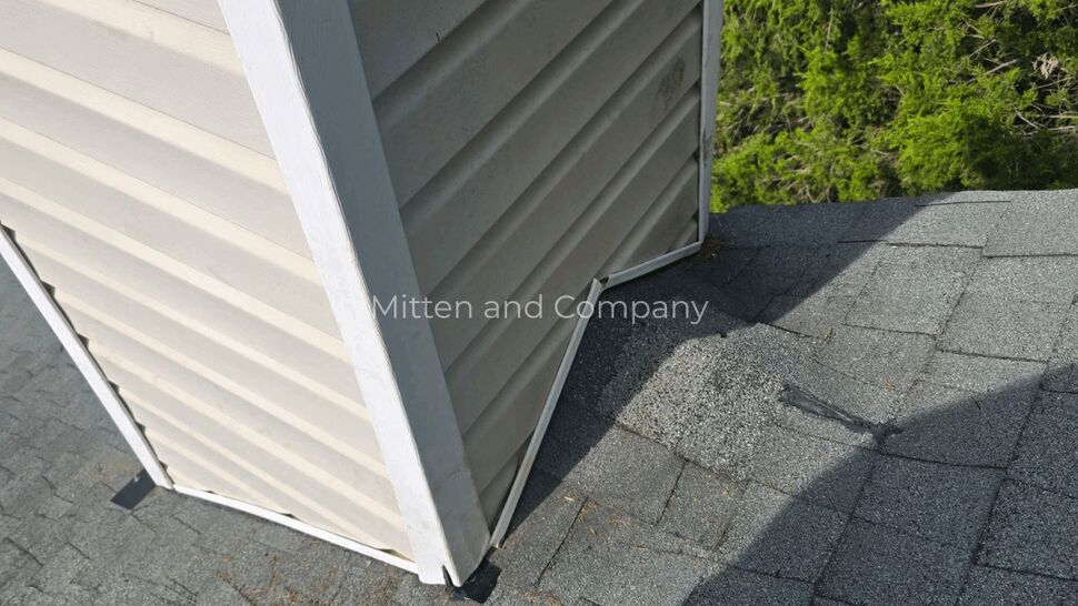 Chimney siding and base flashing | Mitten & Company Chimney chase siding and base flashing at the roof intersection