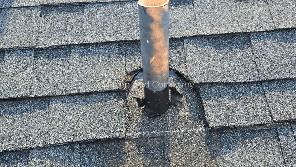 Roof vent with worn seal and exposed metal on asphalt shingles
