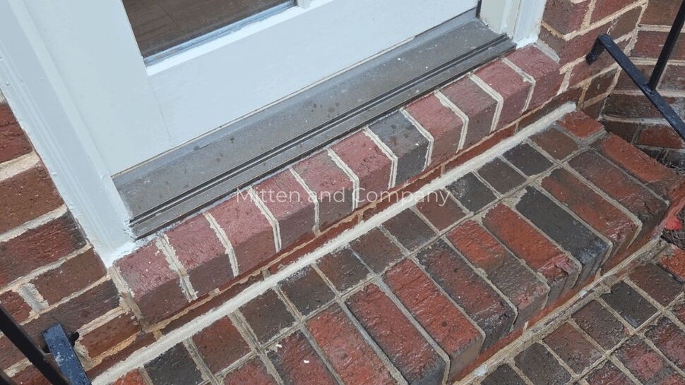 Door Threshold and Brick Trim Siding Check | Mitten & Company Close-up of door threshold and brick steps showing trim