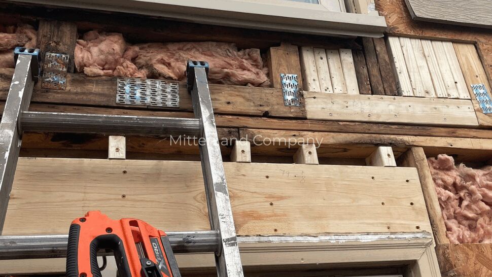 Exposed Wall Window Repair | Mitten & Company Exposed wall framing and insulation around windows during exterior repair