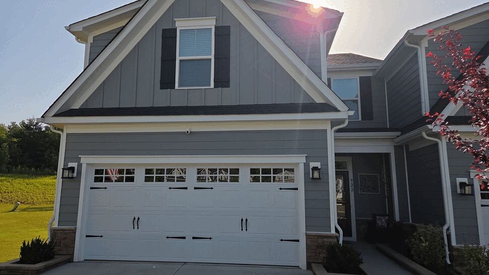 Front Gray Home with Garage and Roof | Mitten & Company Front view of gray house with garage, roof, and gutters