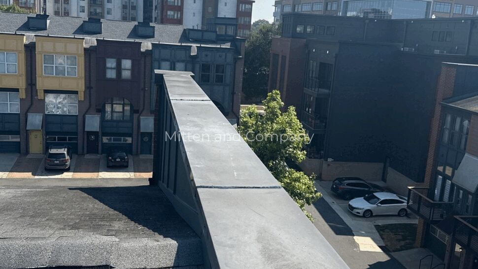 Parapet Cap and Shingle Roofline | Mitten & Company Long parapet cap and adjacent shingled roofline with townhomes in background.