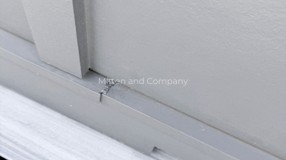 Metal Coping Seam Close-up | Mitten & Company Close-up of metal coping seam and fastener on parapet edge.