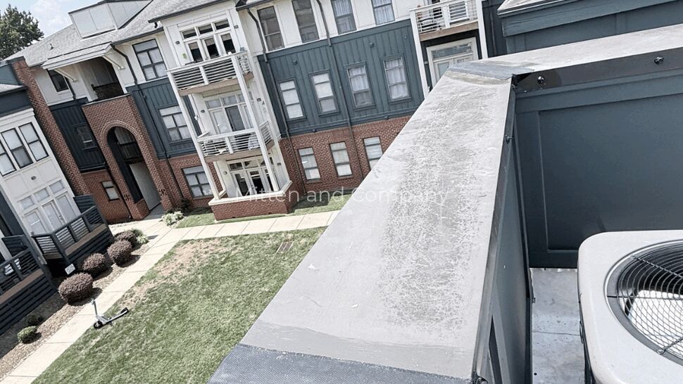 Parapet Cap Patch Over Courtyard | Mitten & Company Parapet cap with patch tape overlooking courtyard at multifamily complex