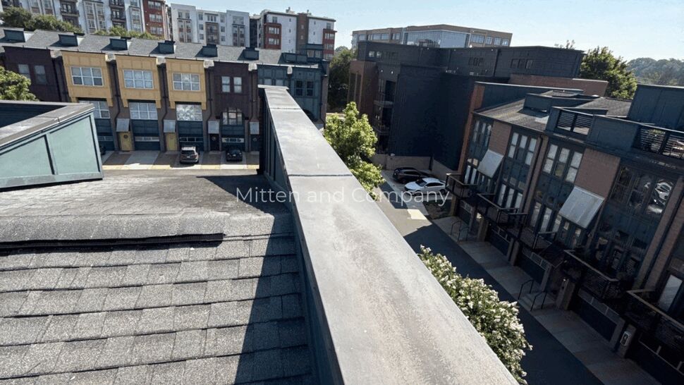 Parapet Rooftop Overlooking Townhomes | Mitten & Company Rooftop parapet view overlooking rows of townhomes and streets below.