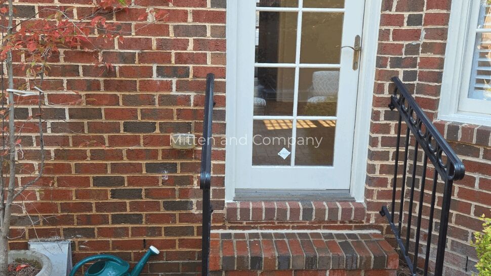 Exterior Entry and Brick Steps Inspection | Mitten & Company Exterior brick steps and door with iron railings