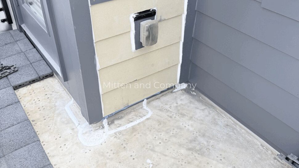 Flat roof area with exposed substrate, sealant patch, and tools visible.