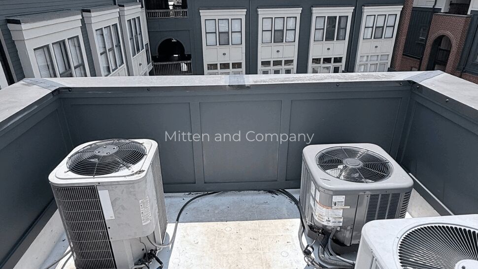 Rooftop HVAC and Roofing Inspection | Mitten & Company Three HVAC units on a small flat roof area behind a parapet wall