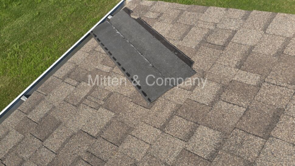 Overhead view of roof vent area with adjacent gutter visible from above.