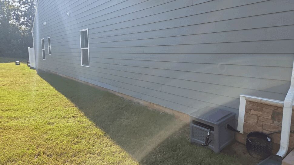 House Side with Gutters and Siding | Mitten & Company Side elevation showing siding, gutter downspout, and lawn