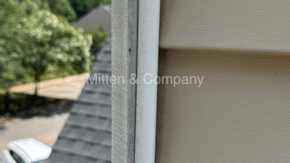 Close-up view of exterior corner trim and vinyl siding details.