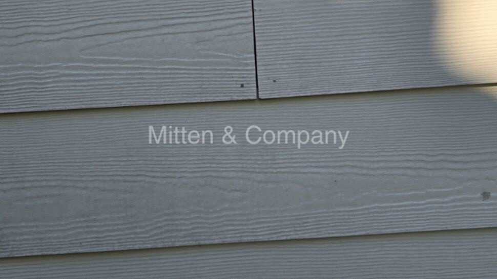 Siding seam showing misaligned boards and shadowing