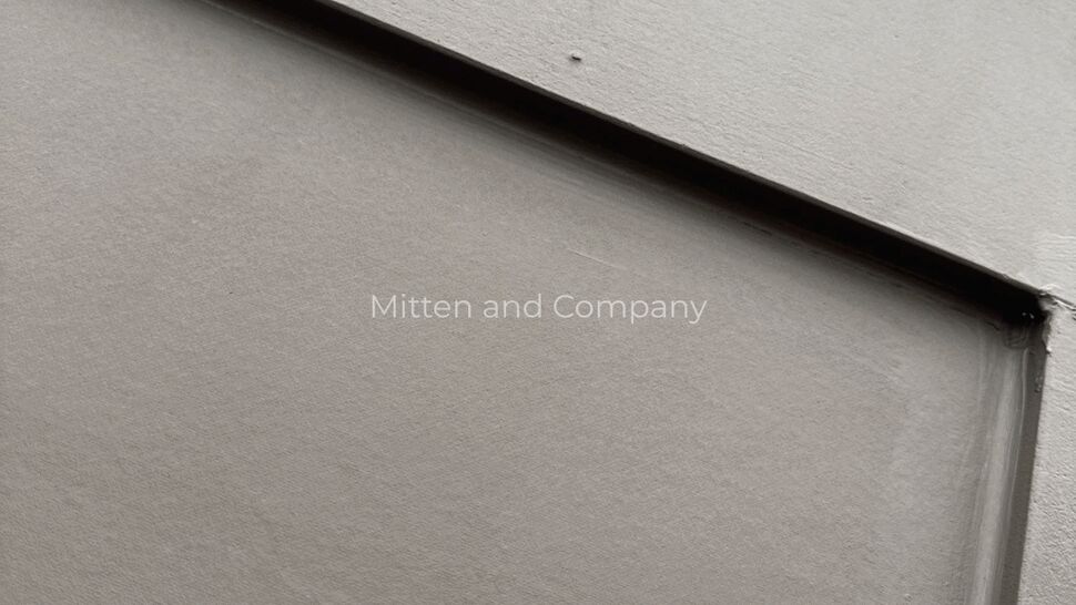 Smooth panel siding close-up | Mitten & Company Close-up of smooth gray panel siding surface with recessed seam details.