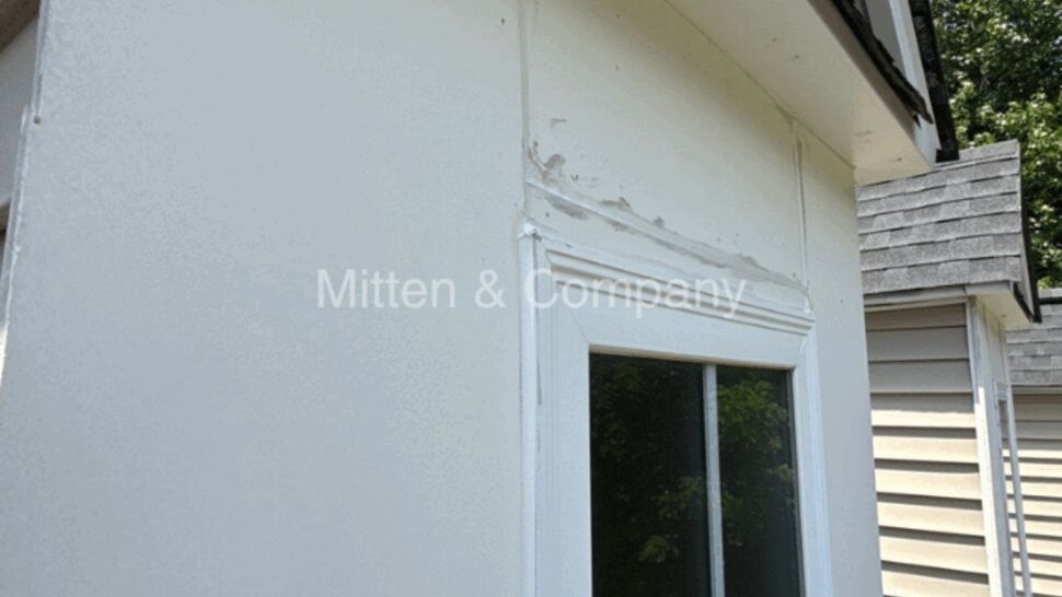 Window trim with peeling caulk and damaged exterior siding.