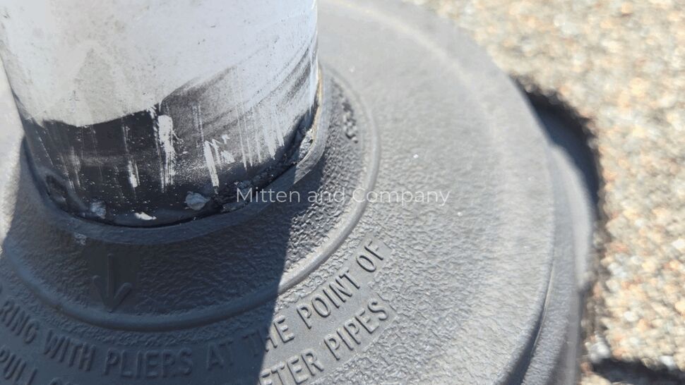 Vent Pipe Sealed with Roof Boot | Mitten & Company Side angle view of white vent pipe sealed into black rubber boot on shingles