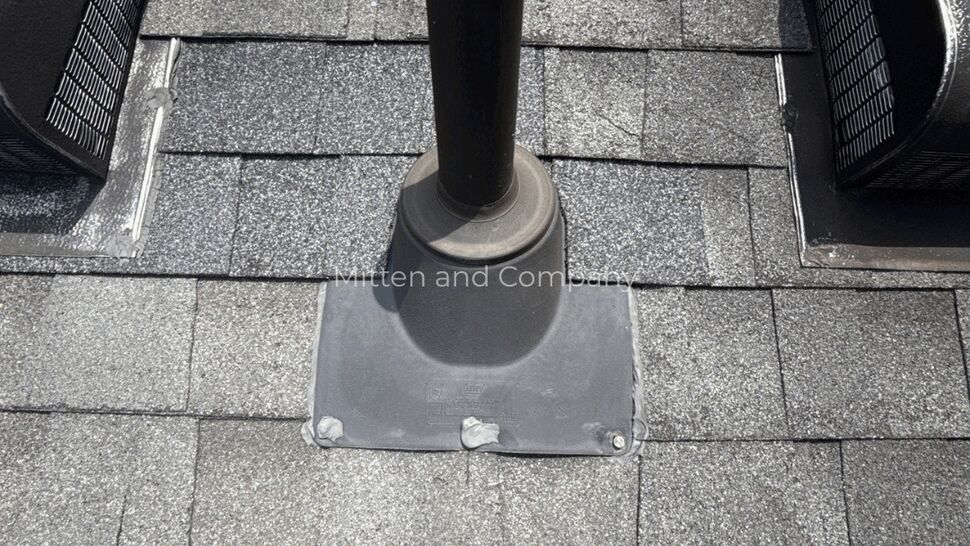 Pipe vent between box vents on roof | Mitten & Company Pipe vent centered between two box vents on an asphalt shingle roof.