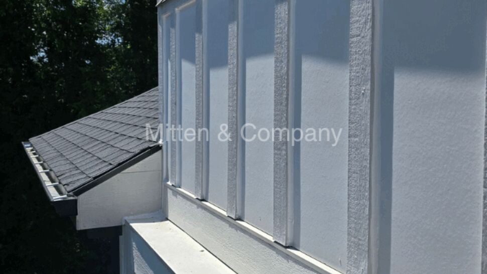 White board-and-batten siding above a shingle roof