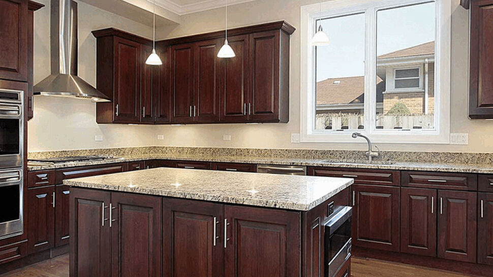 Kitchen with dark wood cabinets and granite-topped island