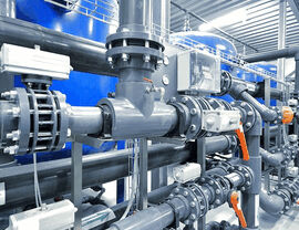 Complex industrial piping with valves and actuators in a mechanical room