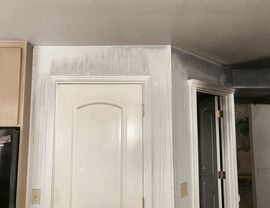 Soot streaks and smoke residue running down walls above an interior door.