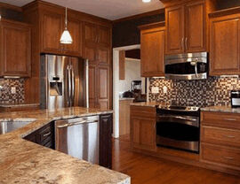 Kitchen with wood cabinets, mosaic backsplash, and granite counters