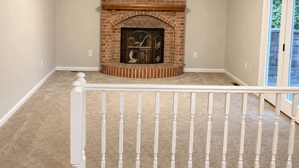 Brick Fireplace Living Room | TSP Contracting Living room with brick fireplace, ceiling fan, carpet, and hardwood flooring