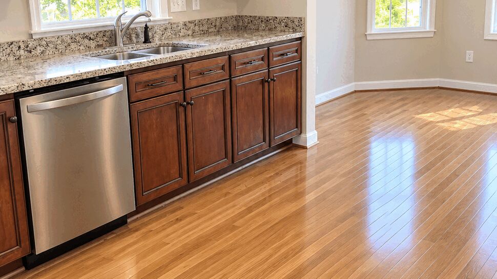 Warm Wood Cabinet Kitchen | TSP Contracting Kitchen with dark wood cabinets, granite counters, stainless appliances, and hardwood flooring