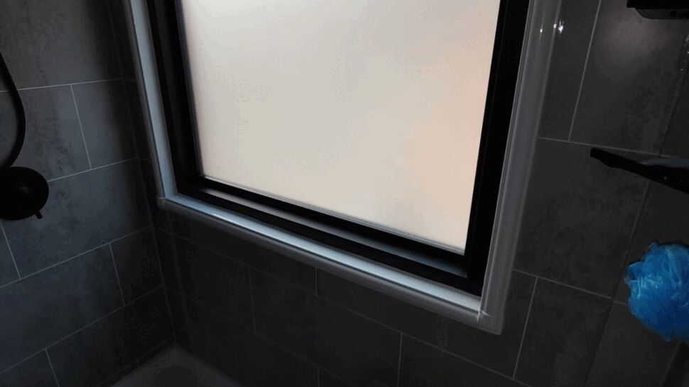 Frosted glass window in a tiled shower for privacy